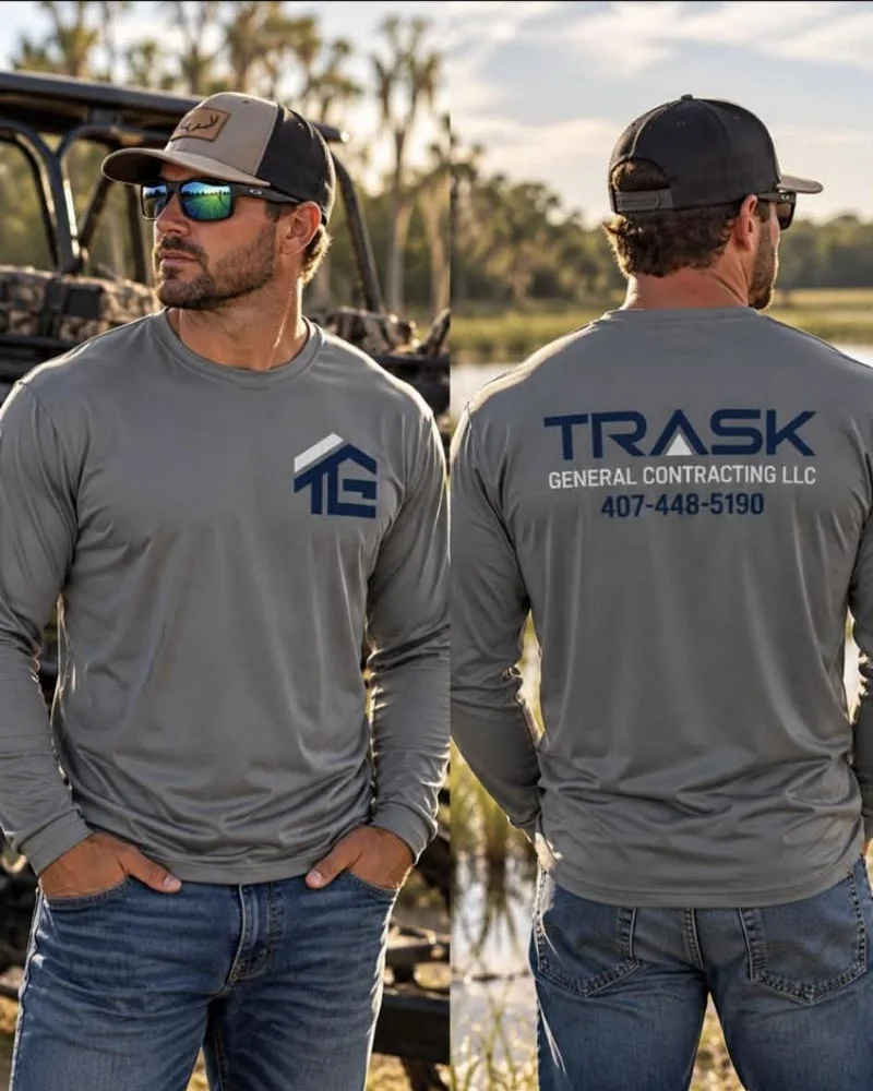 Two crew members in gray long-sleeve shirts with the Trask General Contracting logo on the chest and back